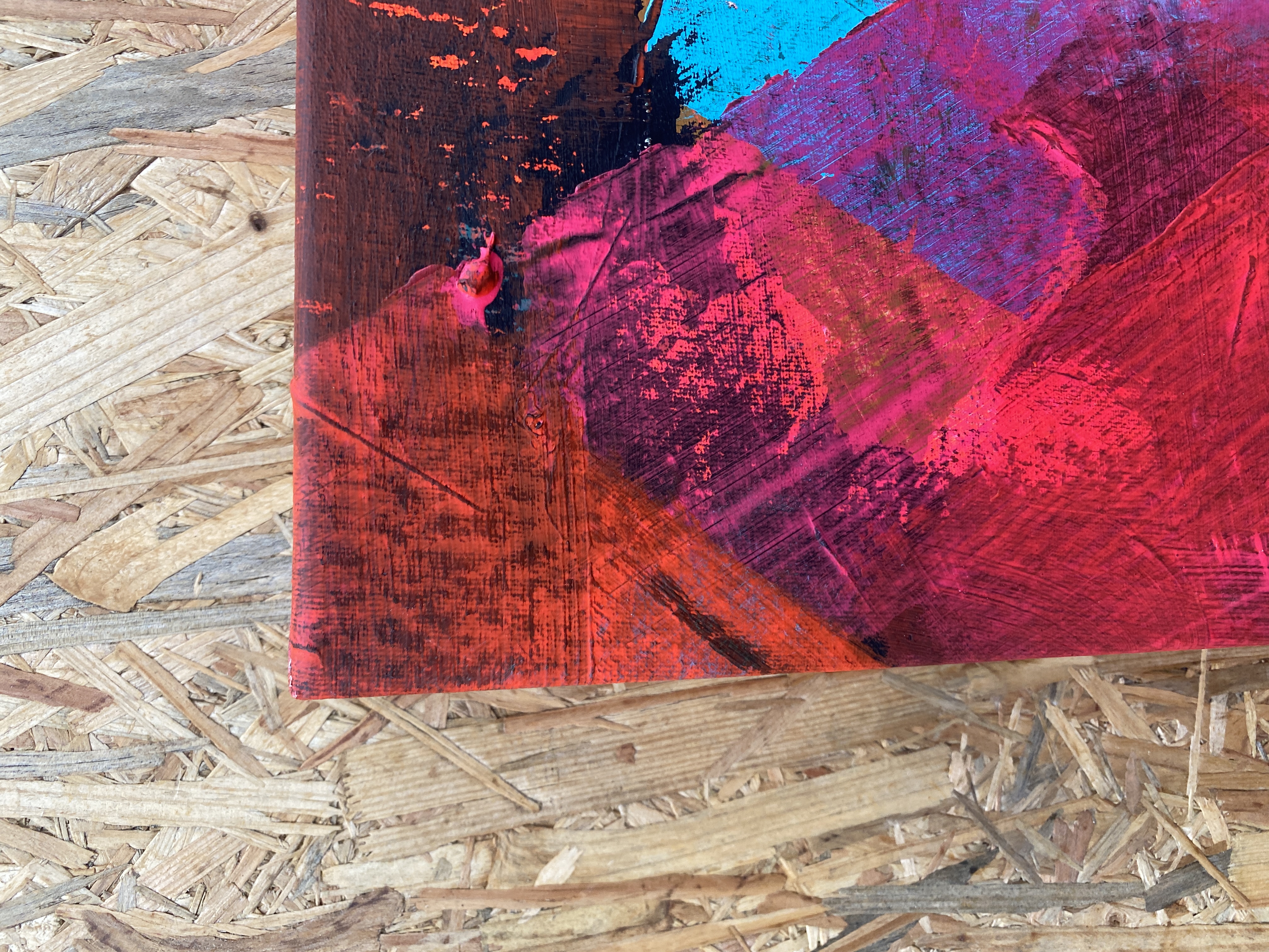 Corner detail — red, magenta, and blue paint edge